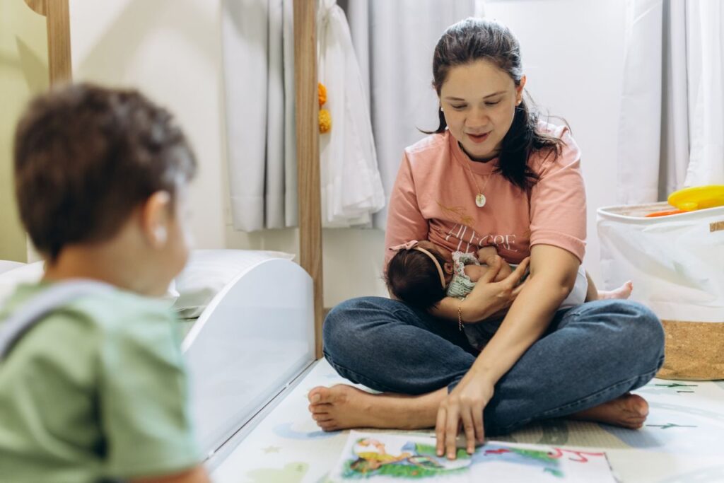 Mother spending quality time reading to her children in a cozy indoor setting.