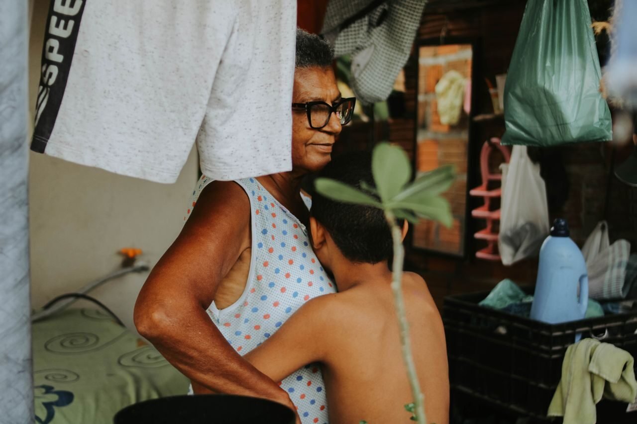A loving embrace between a grandmother and her grandson at home, depicting warmth and family bonds.