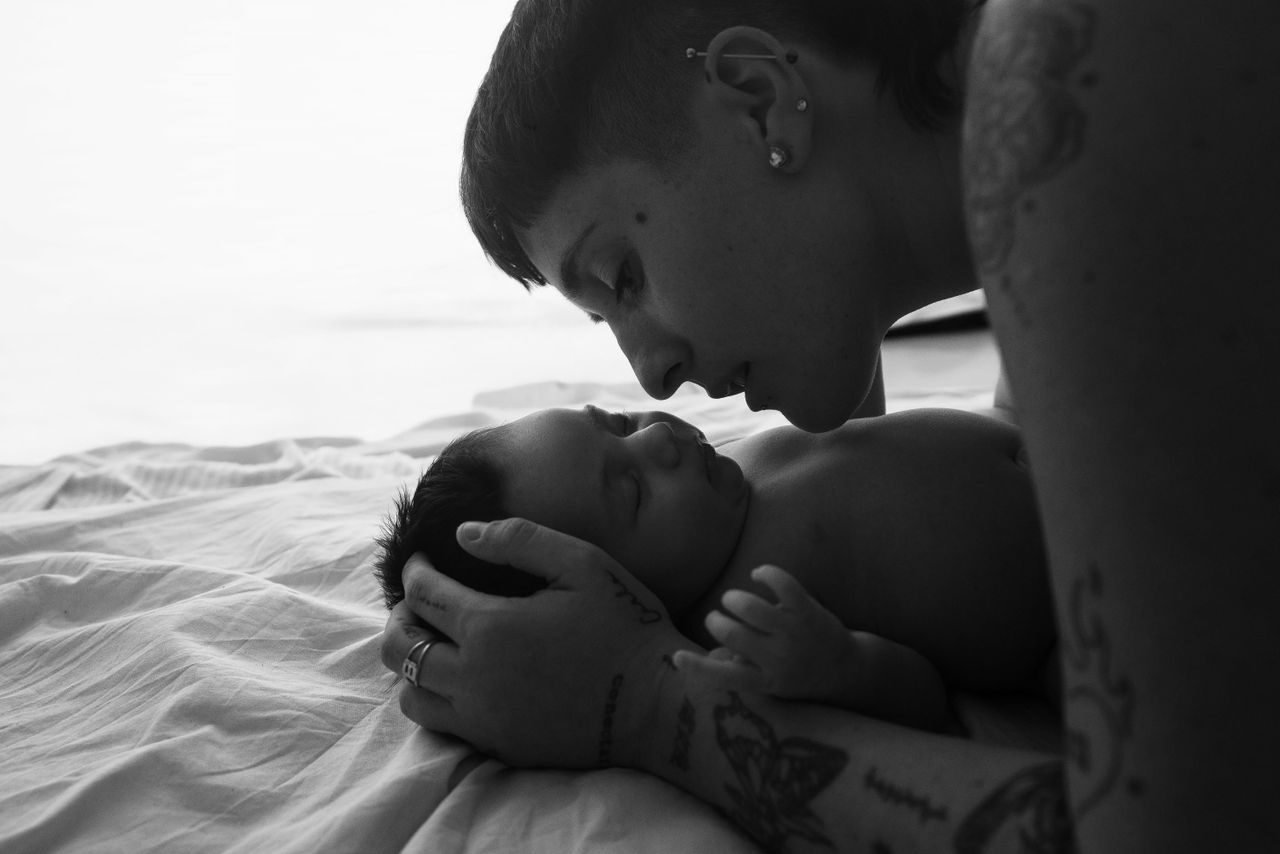 A touching black and white photo capturing a tender moment between a mother and her baby.