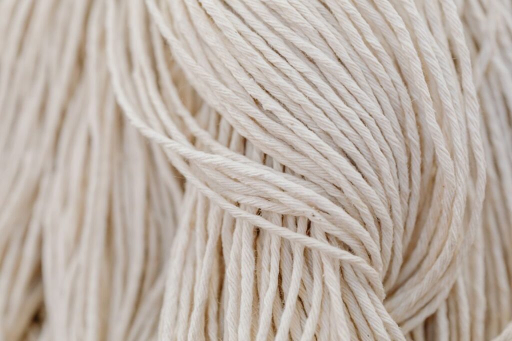 Detailed view of white yarn in a tangled arrangement. Perfect for crafting themes.