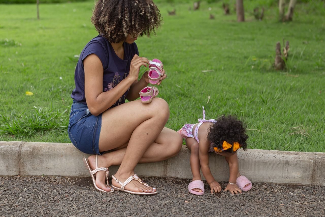 A mother and daughter enjoying time together outdoors, depicting love and care.