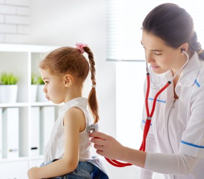 doctor examining a child girl in a hospital